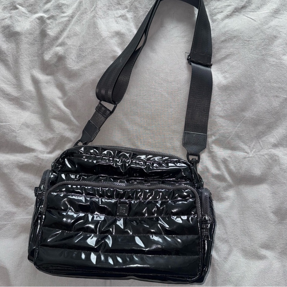 Think Royln Voyager Travel Bag in Black Patent Quilted Nylon Crossbody